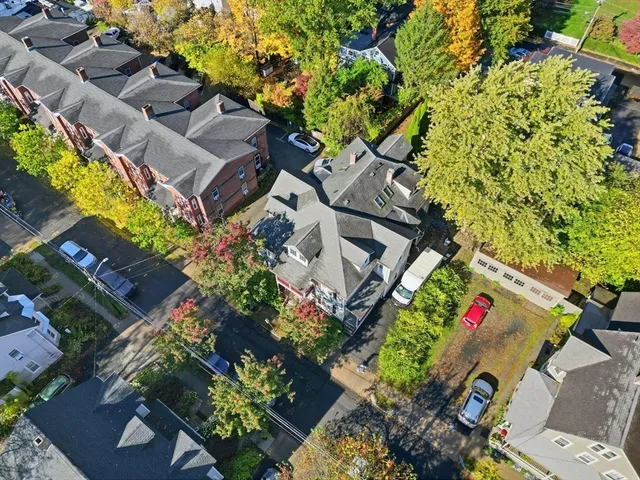an aerial view of a house with a yard