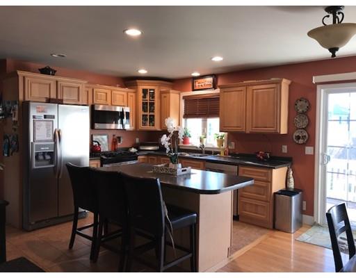 35 Wyndham Court Fall River, MA 02721 - Photo 9 of 14 a kitchen with stainless steel appliances granite countertop a sink a stove a refrigerator cabinets and a dining table