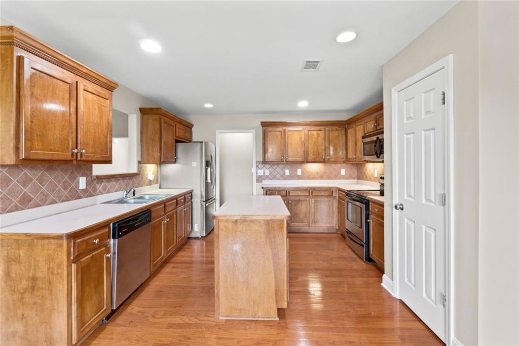 241 Red Bud Road Jefferson, GA 30549 - Photo 21 of 43 a large kitchen with stainless steel appliances lots of counter top space and cabinets