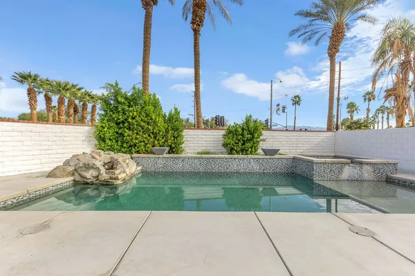 a view of a swimming pool with a lounge chairs