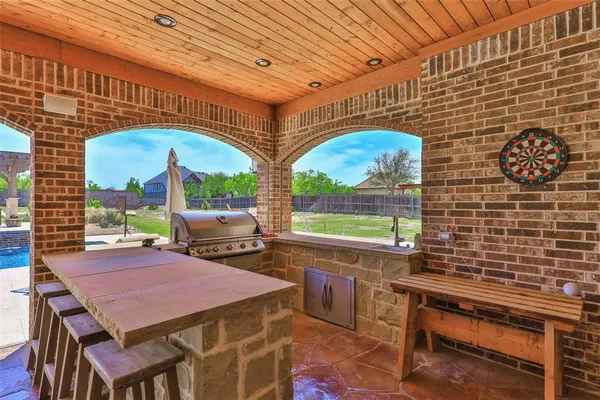 a view of a patio with a table and chairs
