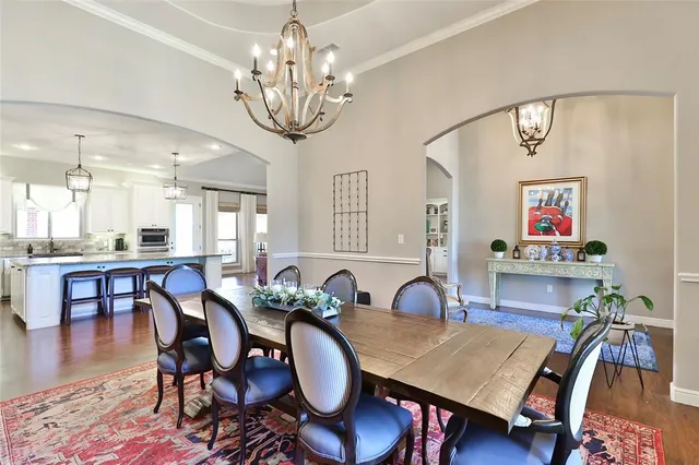 a large kitchen with stainless steel appliances lots of counter space and wooden floor