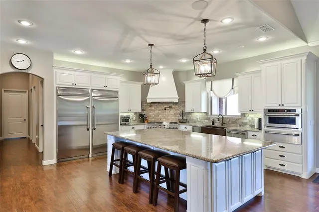 a living room with furniture fireplace and a large window