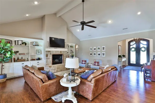 a living room with furniture fireplace and flat screen tv