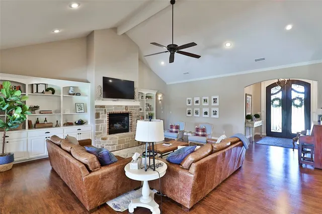 a living room with furniture fireplace and flat screen tv