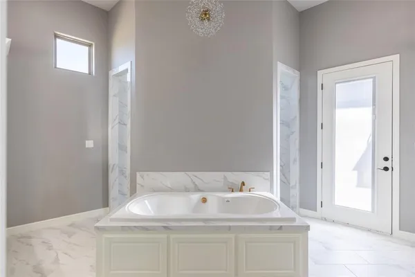 a bathroom with a bathtub and a shower