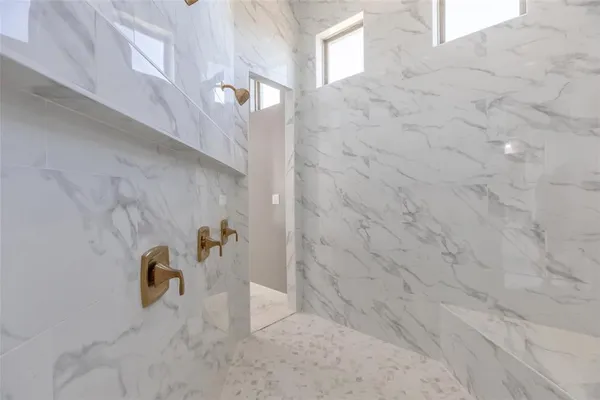 a bathroom with a double vanity sink a mirror and a shower