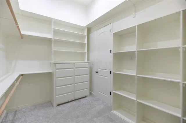 a bathroom with a granite countertop toilet sink and mirror