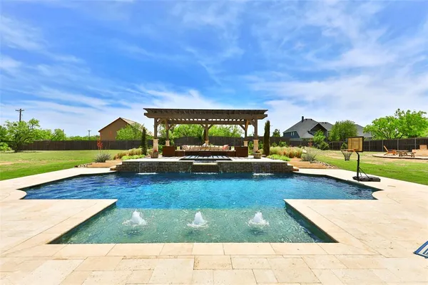 a view of a swimming pool with lounge chairs