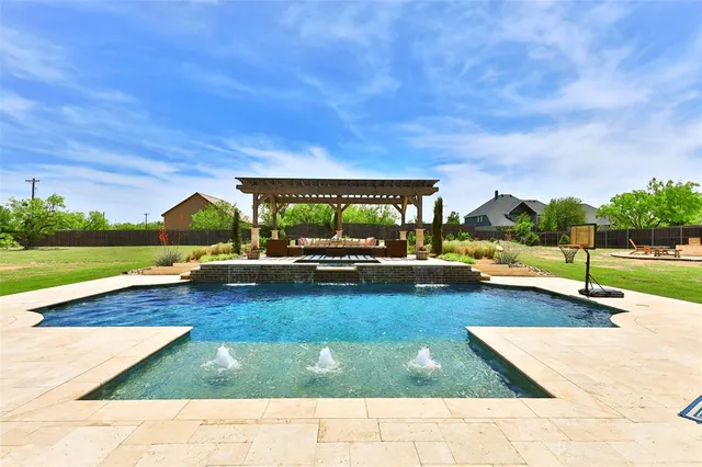 a view of a swimming pool with lounge chairs