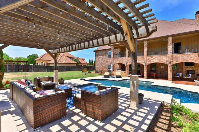 a view of a patio with table and chairs potted plants with wooden floor