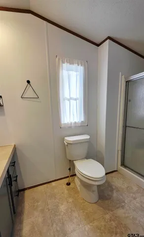 a white toilet sitting next to a bathroom sink
