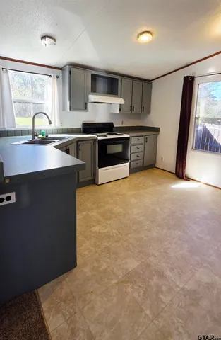 a kitchen with stainless steel appliances a sink stove and refrigerator