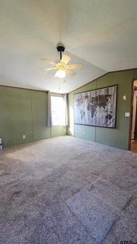 a view of a room with window and ceiling fan