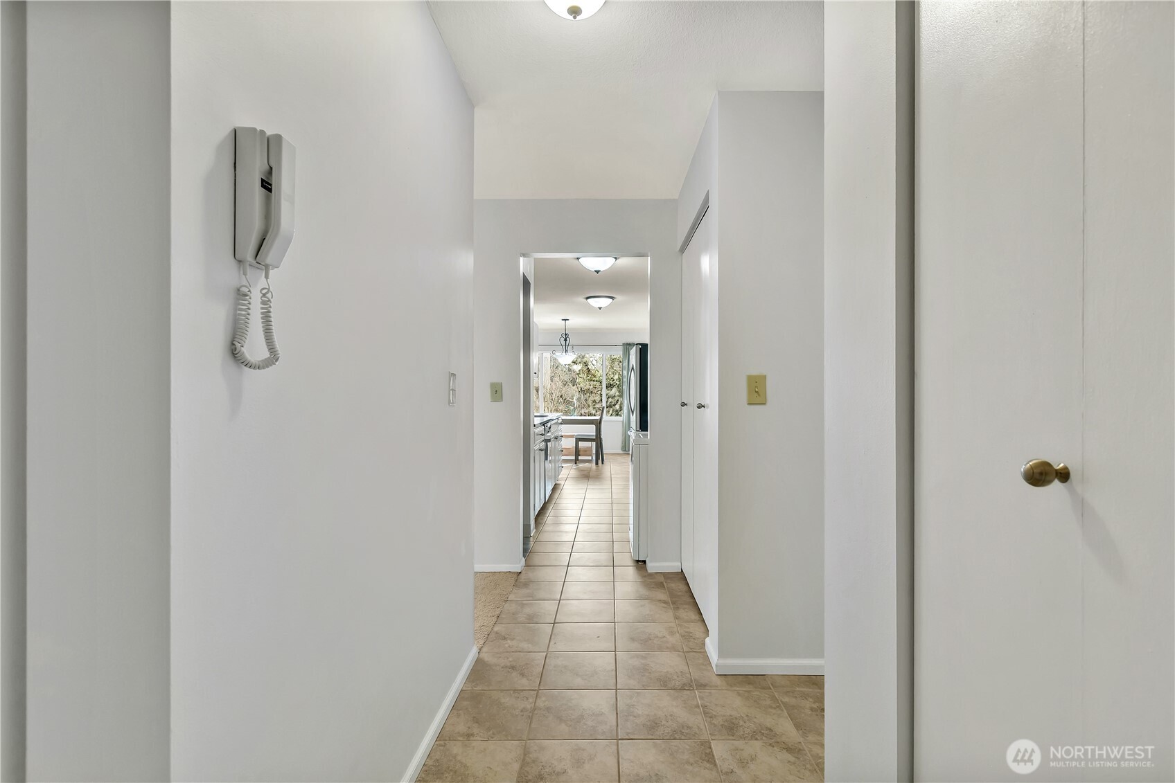 4545 Sand Point Way Northeast, Unit 207 Seattle, WA 98105 - Photo 5 of 25 a view of a hallway with wooden floor