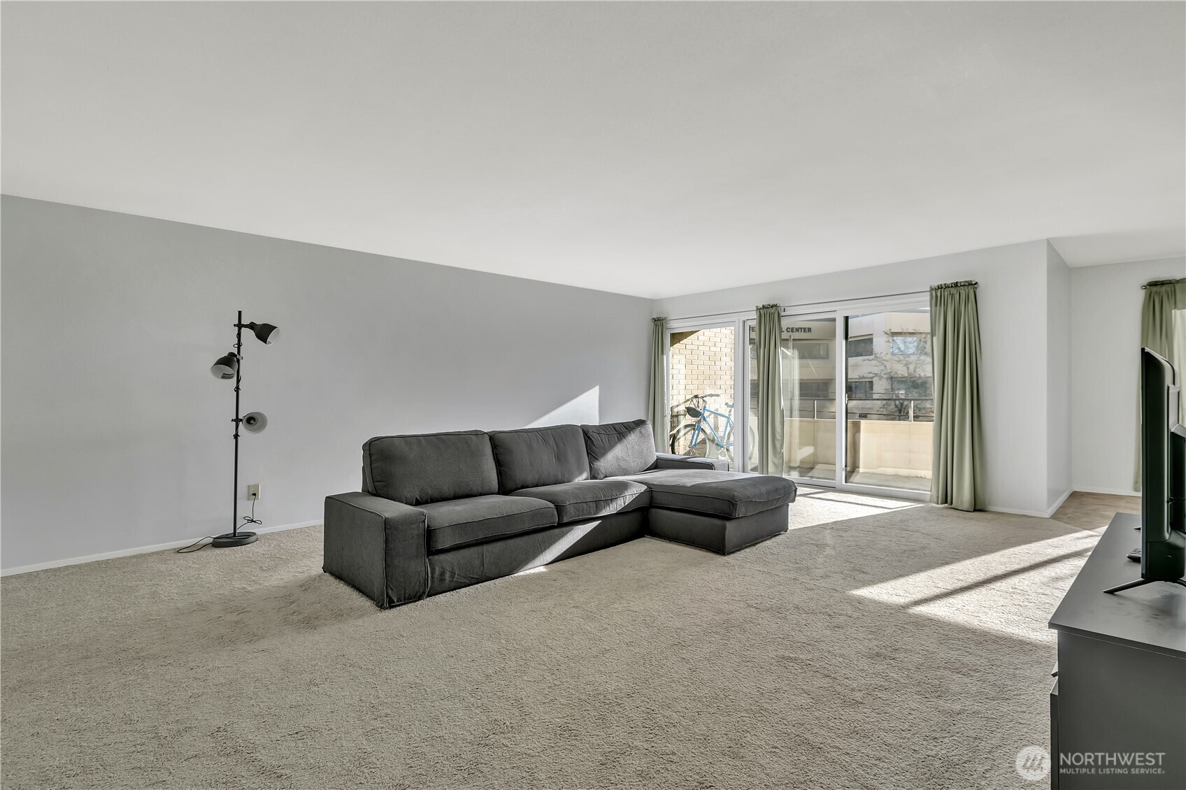 4545 Sand Point Way Northeast, Unit 207 Seattle, WA 98105 - Photo 6 of 25 a living room with furniture and a flat screen tv