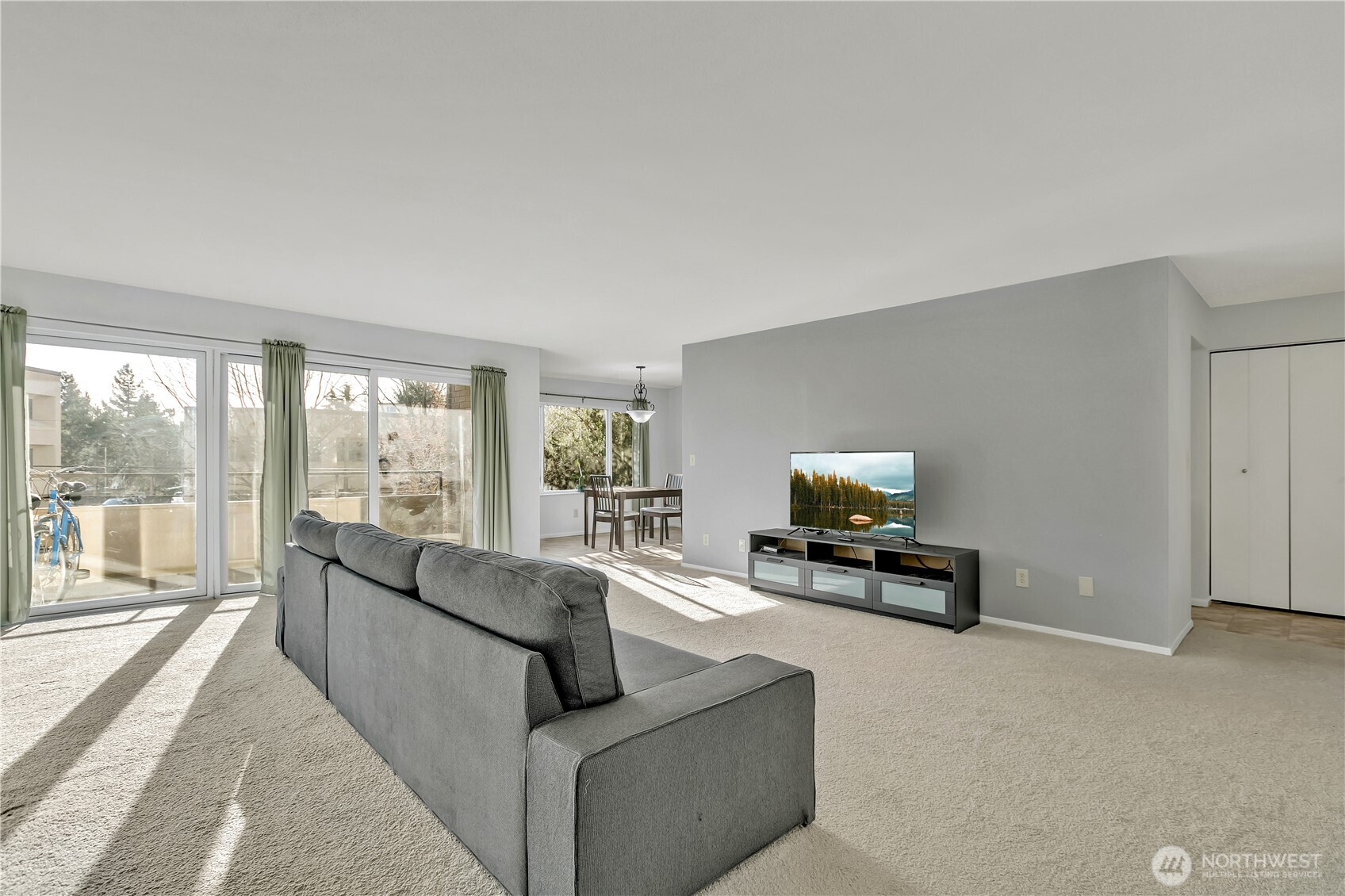 4545 Sand Point Way Northeast, Unit 207 Seattle, WA 98105 - Photo 7 of 25 a living room with furniture and a flat screen tv