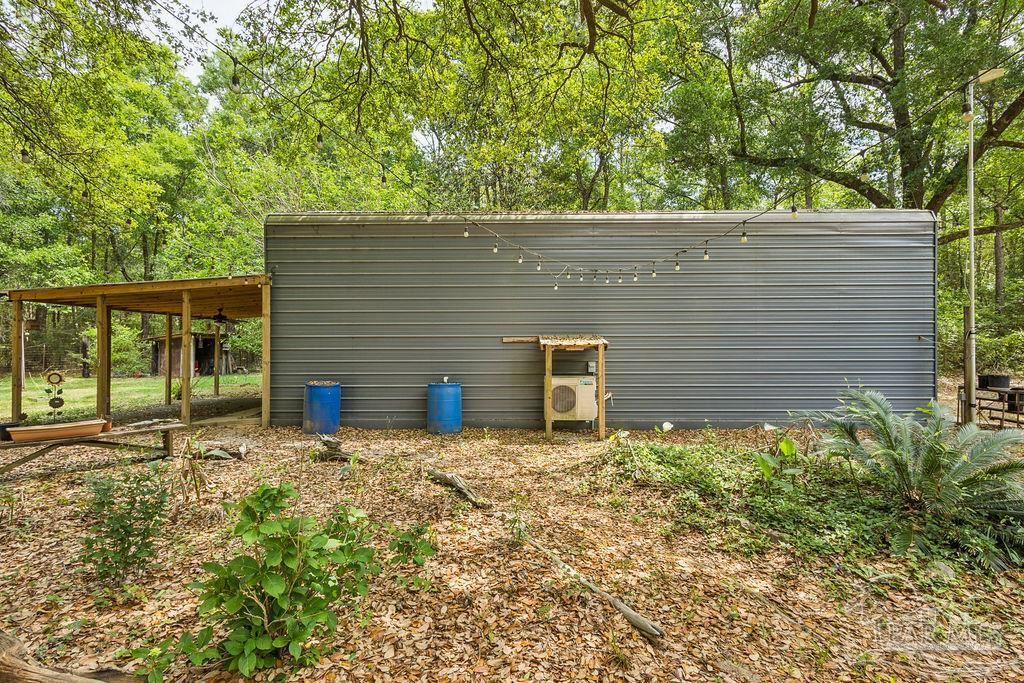 8938 Pioneer Road Holt, FL 32564 - Photo 30 of 44 a backyard of a house with lots of green space
