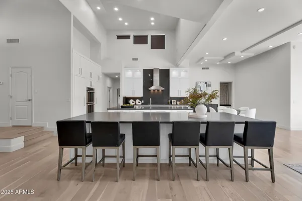 a kitchen with white cabinets and sink