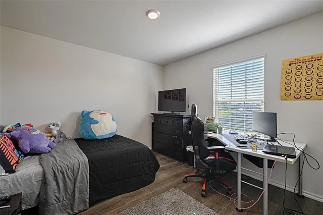 a bedroom with a bed and a desk