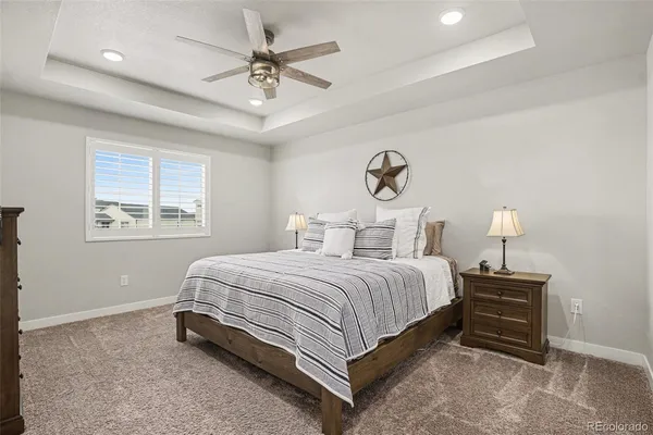 a spacious bedroom with a bed and a window