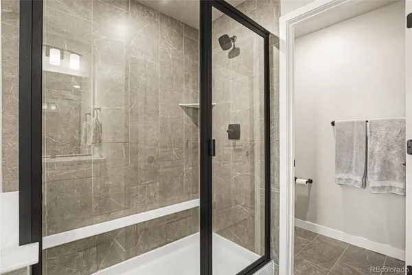 a bathroom with a glass shower door