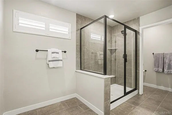 a bathroom with a shower and mirror
