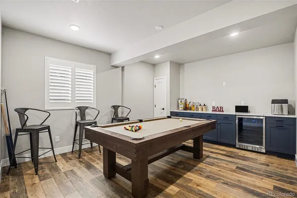 a room with a table chairs and wooden floor