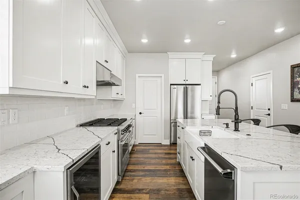 a kitchen with a sink stove and cabinets