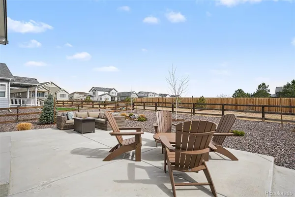 a view of a terrace with furniture and city view