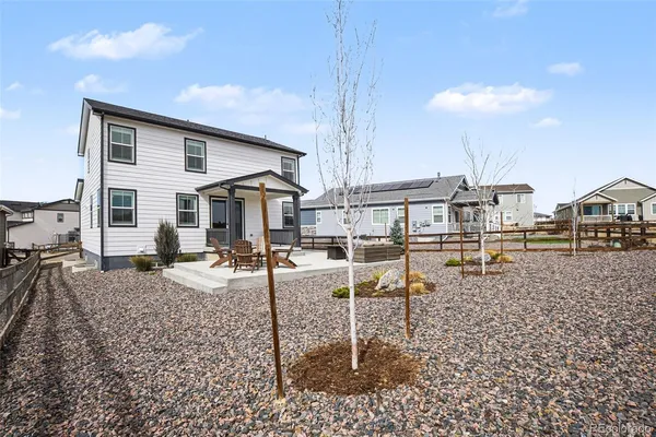 a view of a house with backyard porch and sitting area