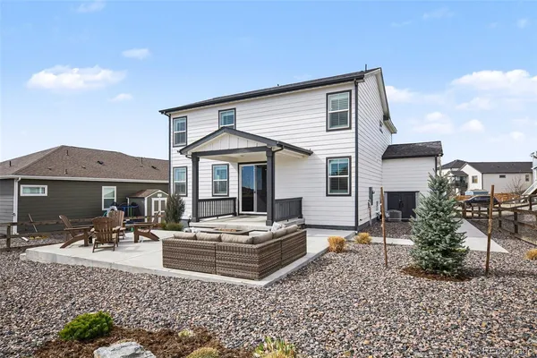 a view of a house with backyard and sitting area