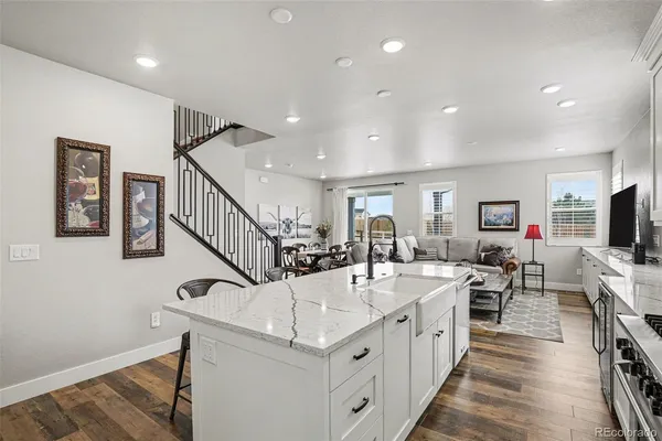 a kitchen with sink stove and cabinets