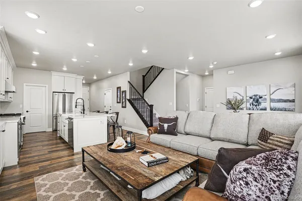 a living room with furniture and kitchen view