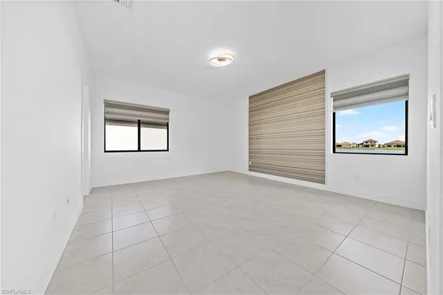 an empty room with windows and closet