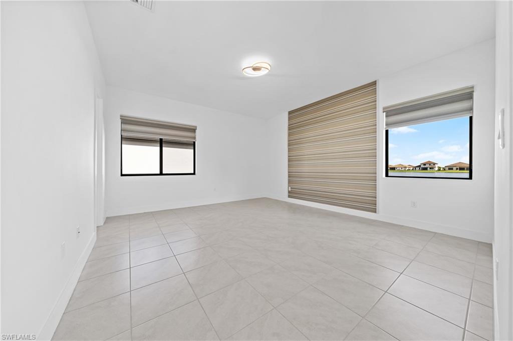 4947 Brigata Way Avenue Immokalee, FL 34142 - Photo 13 of 50 an empty room with windows and closet