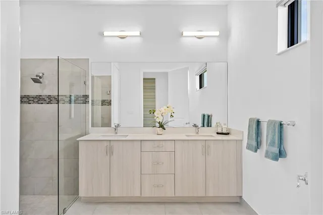 a bathroom with a double vanity sink and mirror