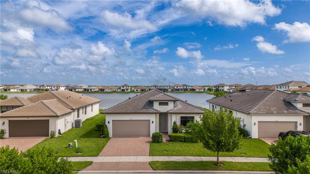 4947 Brigata Way Avenue Immokalee, FL 34142 - Photo 2 of 50 a view of a white building among the street and a yard