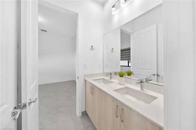 a bathroom with a sink vanity and a mirror