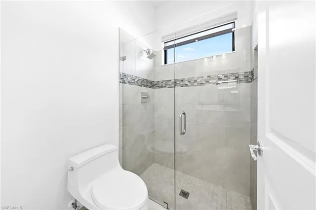 a bathroom with a shower and toilet