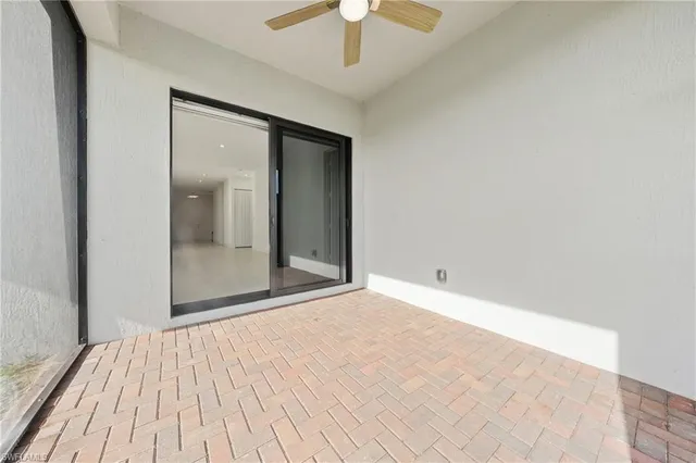 a view of an empty room with glass door
