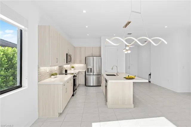 a large white kitchen with a large window
