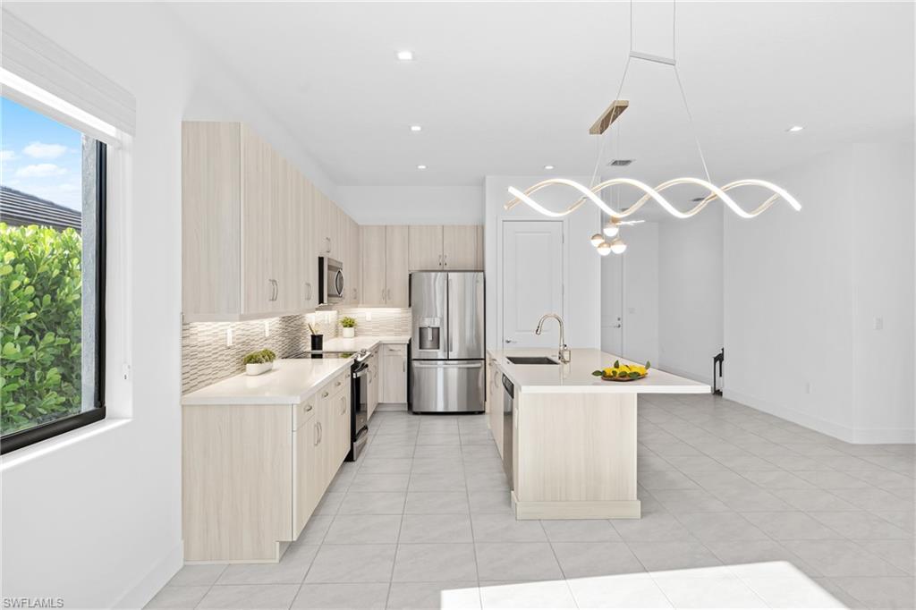 4947 Brigata Way Avenue Immokalee, FL 34142 - Photo 36 of 50 a large white kitchen with a large window