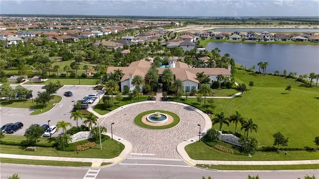 an aerial view of a house with a garden and lake view