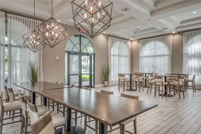 a living room with patio furniture and a flat screen tv