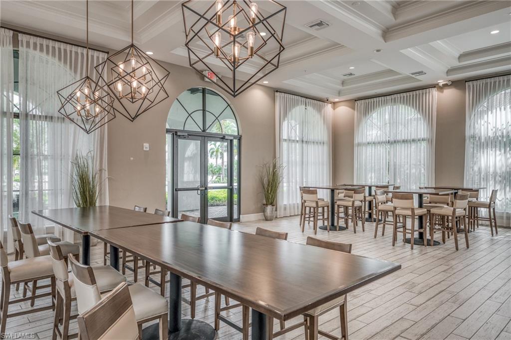 4947 Brigata Way Avenue Immokalee, FL 34142 - Photo 45 of 50 an open kitchen with chandelier dining table and wooden floor