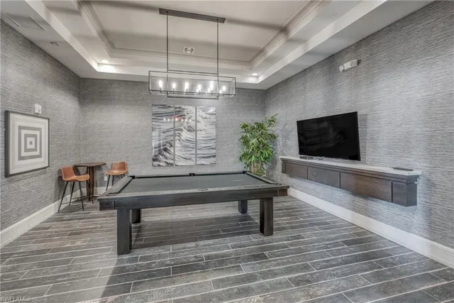 a kitchen with a sink and wooden floor