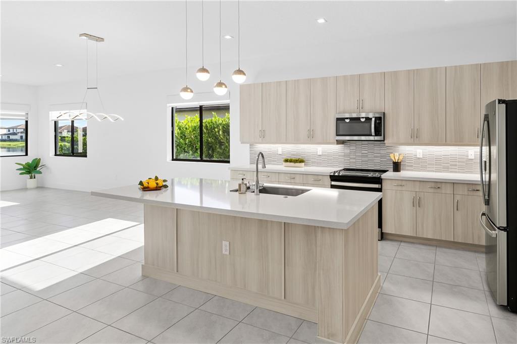 4947 Brigata Way Avenue Immokalee, FL 34142 - Photo 5 of 50 a kitchen with cabinets a sink and appliances