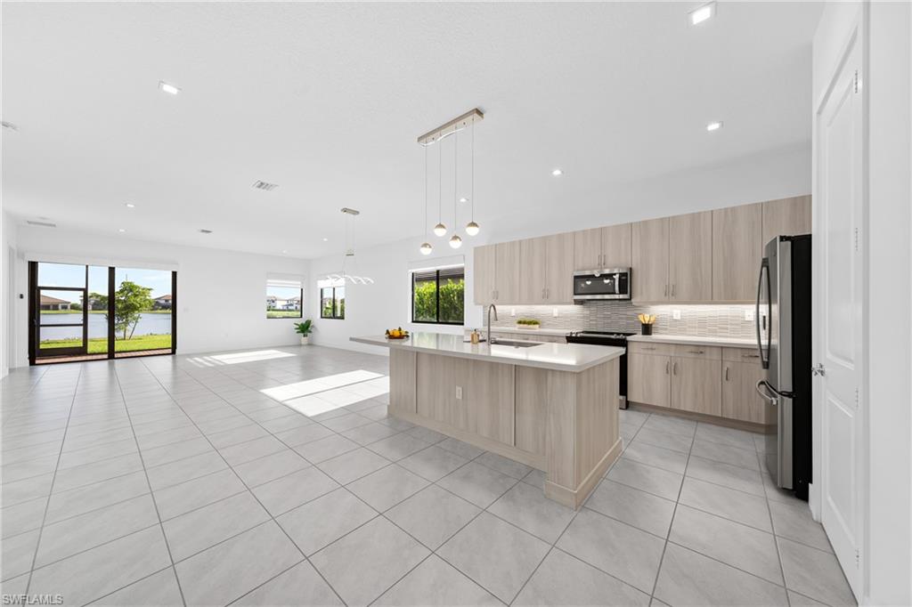 4947 Brigata Way Avenue Immokalee, FL 34142 - Photo 6 of 50 a large white kitchen with a sink and cabinets