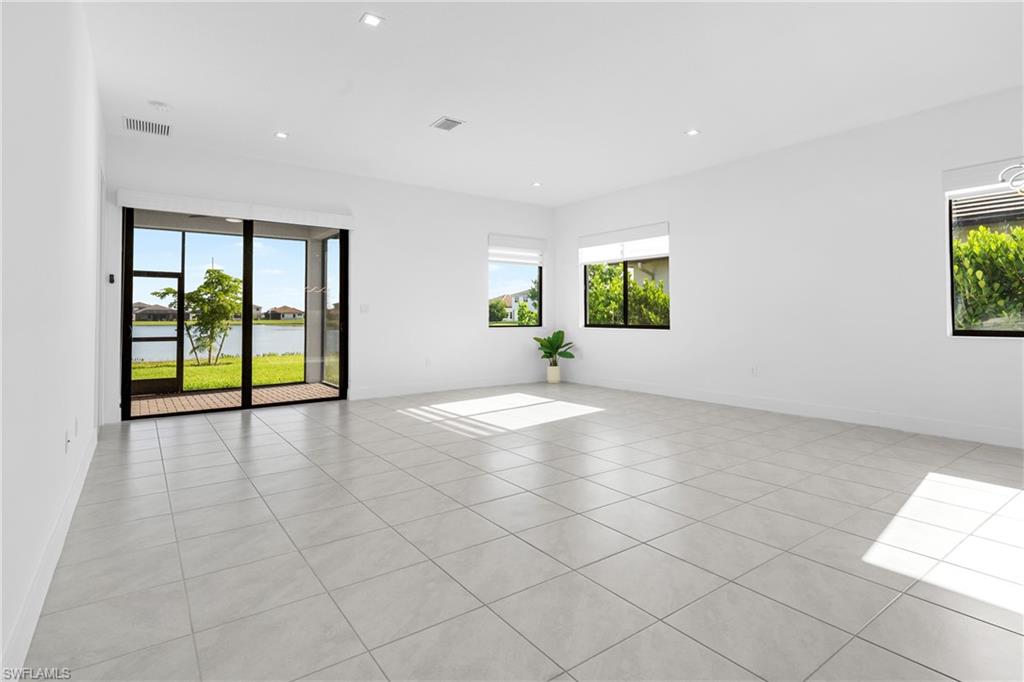 4947 Brigata Way Avenue Immokalee, FL 34142 - Photo 9 of 50 wooden floor in an empty room with a window